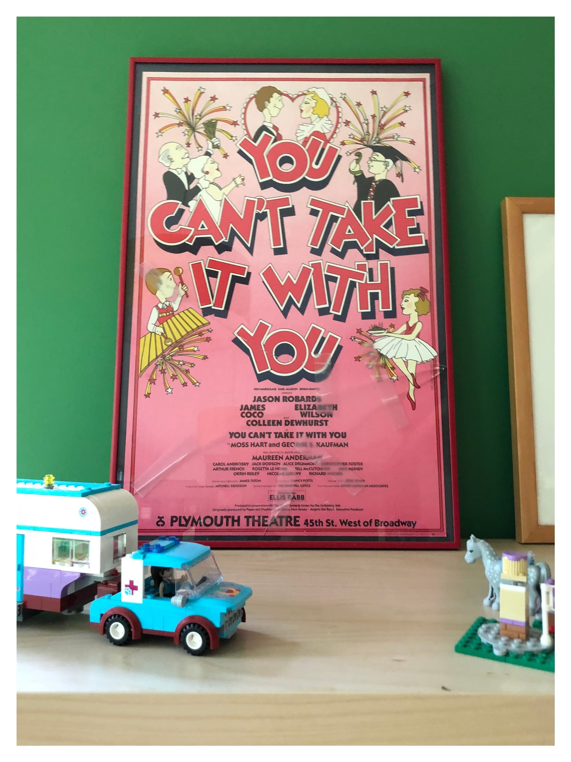 A poster of the 1984 play "You Can't Take it with You", with a cracked and taped glass.